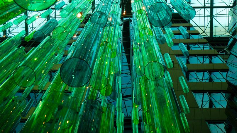 What are the key drivers of positive abnormal stock returns following a firm’s issuance of green bonds?